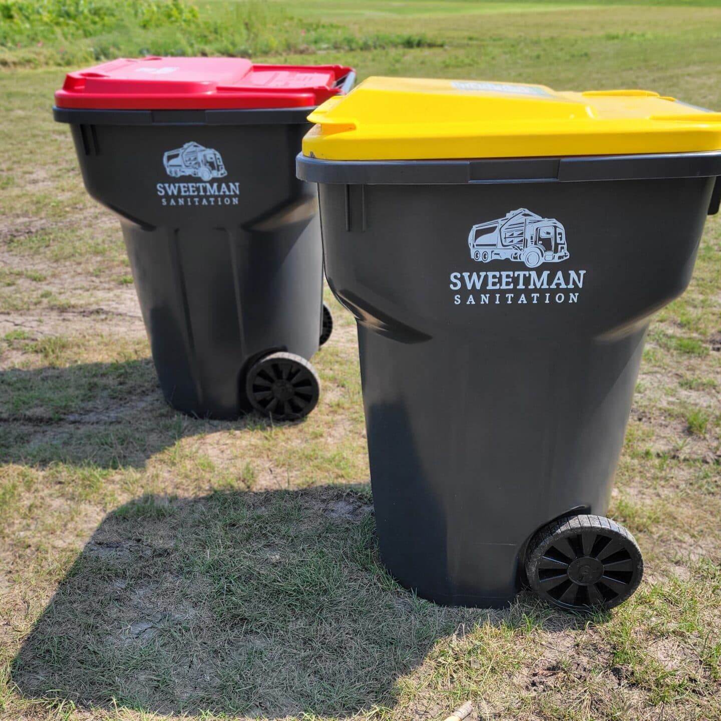 Black Trash Bins on Grass Lawn